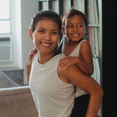 Ashley T., first-time surrogate mother smiling with her daughter - Harmony Surrogacy